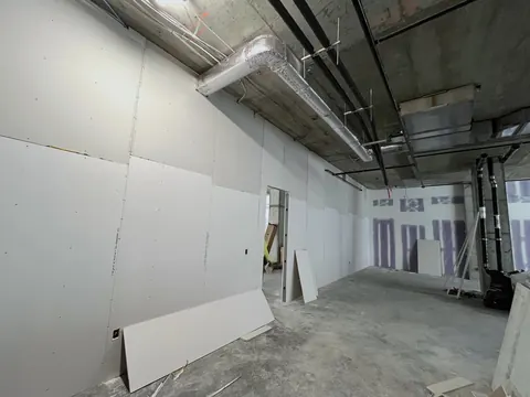 Boarded partitions on the open floor.