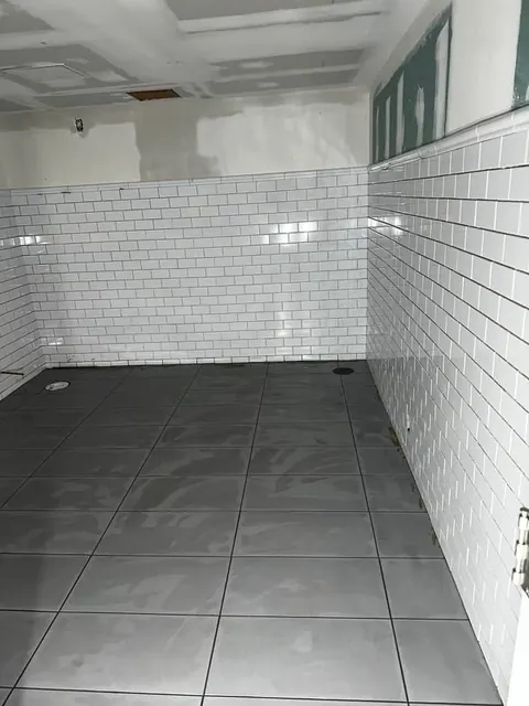 Subway tile wainscot meeting the new floor.